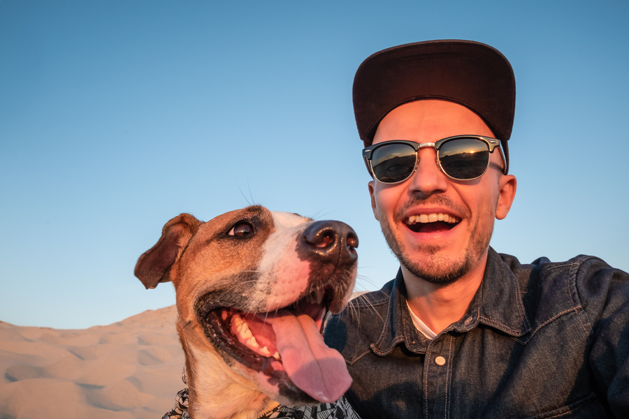 Funny best friends concept: human taking a selfie with dog.